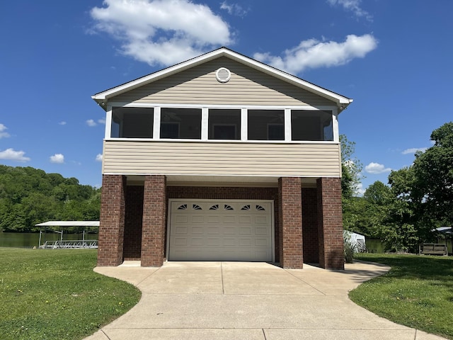 1473 Chapmansboro Rd, Chapmansboro, TN 37035 - traditional-style house with concrete driveway, a front lawn, a sunroom, and a garage
