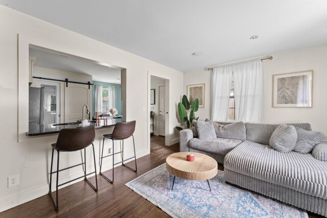 living room featuring baseboards, recessed lighting, and dark wood-style flooring