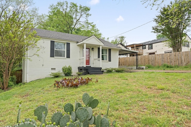 view of front of house featuring a front lawn, fence, brick siding, a shingled roof, and crawl space