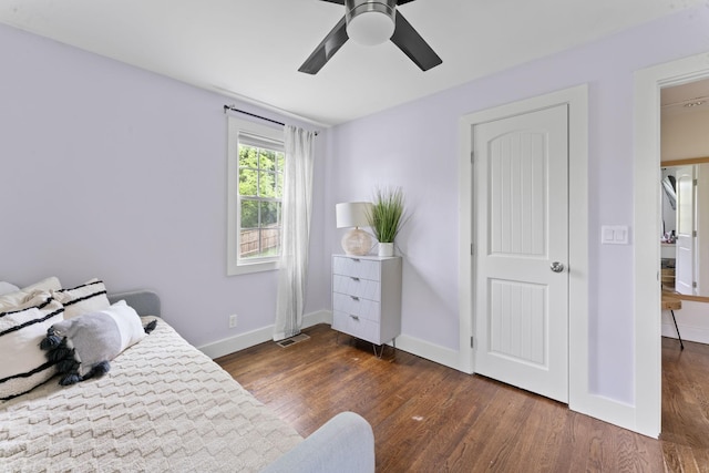 bedroom with visible vents, baseboards, dark wood-style floors, and ceiling fan