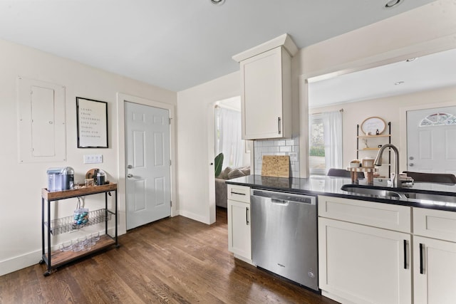 kitchen featuring stainless steel dishwasher, dark wood-style floors, a sink, baseboards, and white cabinetry