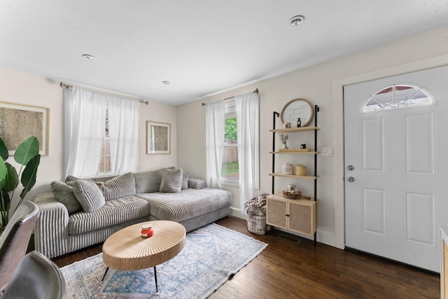 living area with visible vents and dark wood-type flooring