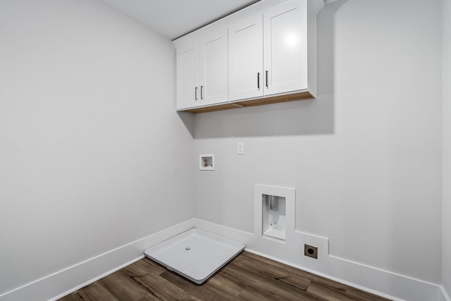 washroom with hookup for a washing machine, electric dryer hookup, cabinet space, dark wood-style flooring, and baseboards