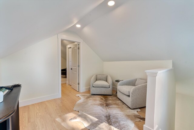 living area featuring baseboards, recessed lighting, light wood-style flooring, and lofted ceiling