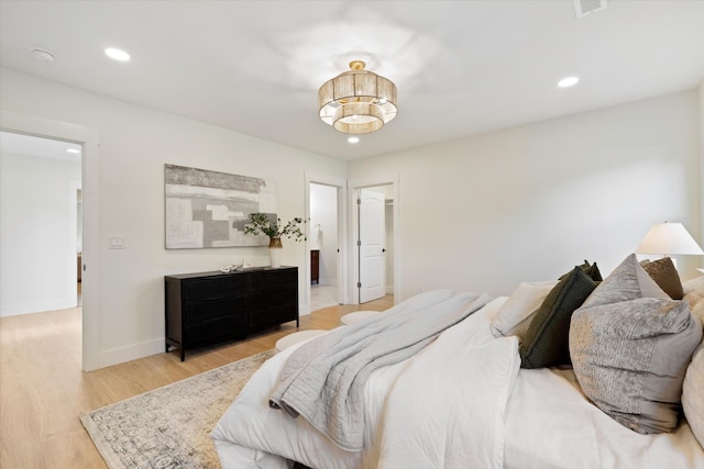 bedroom with recessed lighting, light wood-style flooring, and baseboards