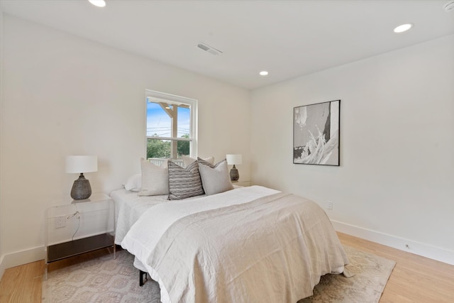 bedroom featuring recessed lighting, wood finished floors, and visible vents