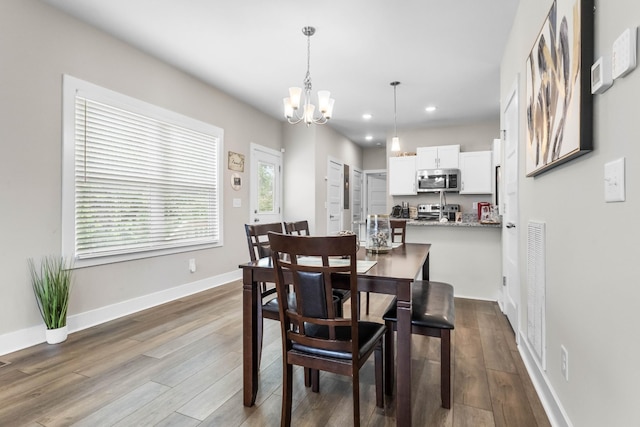 309 Cedar Ct, Clarksville, TN 37042 - dining room with a chandelier, dark wood finished floors, recessed lighting, and baseboards