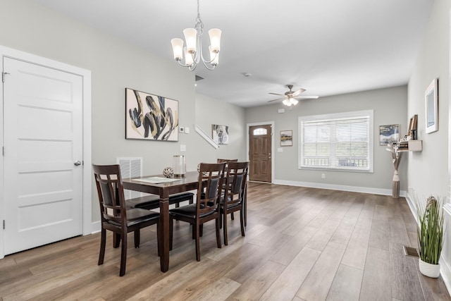 309 Cedar Ct, Clarksville, TN 37042 - dining area with light wood finished floors, a chandelier, a ceiling fan, and baseboards