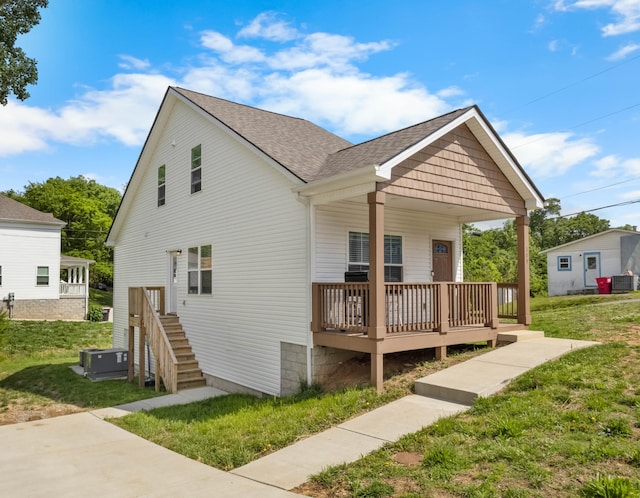 309 Cedar Ct, Clarksville, TN 37042 - view of front facade with a front yard, central AC, a shingled roof, and covered porch