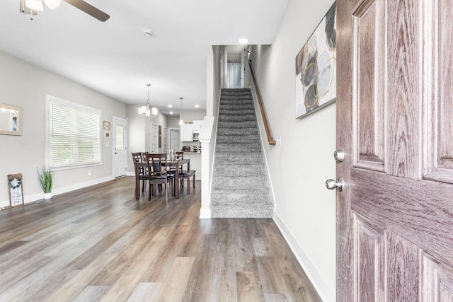 309 Cedar Ct, Clarksville, TN 37042 - foyer entrance with stairway, ceiling fan, wood finished floors, a chandelier, and baseboards