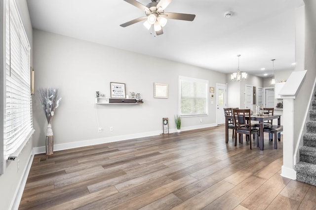 309 Cedar Ct, Clarksville, TN 37042 - dining room with stairs, wood finished floors, a ceiling fan, a chandelier, and baseboards