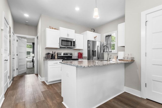 309 Cedar Ct, Clarksville, TN 37042 - kitchen with appliances with stainless steel finishes, light stone counters, white cabinetry, a peninsula, and recessed lighting