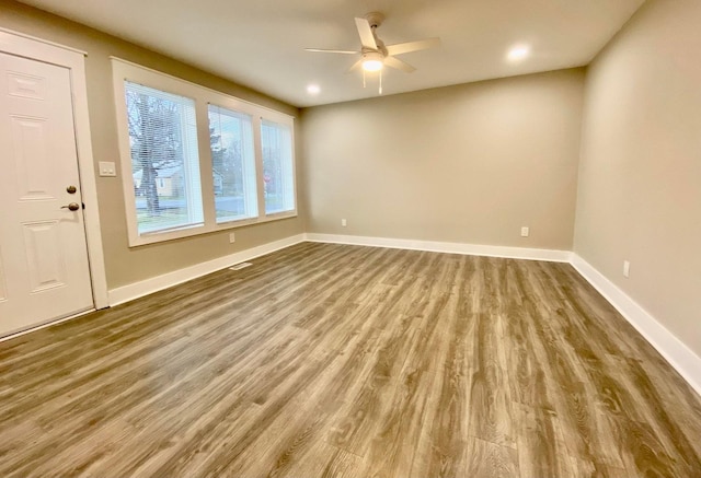 interior space with ceiling fan, baseboards, wood finished floors, and recessed lighting