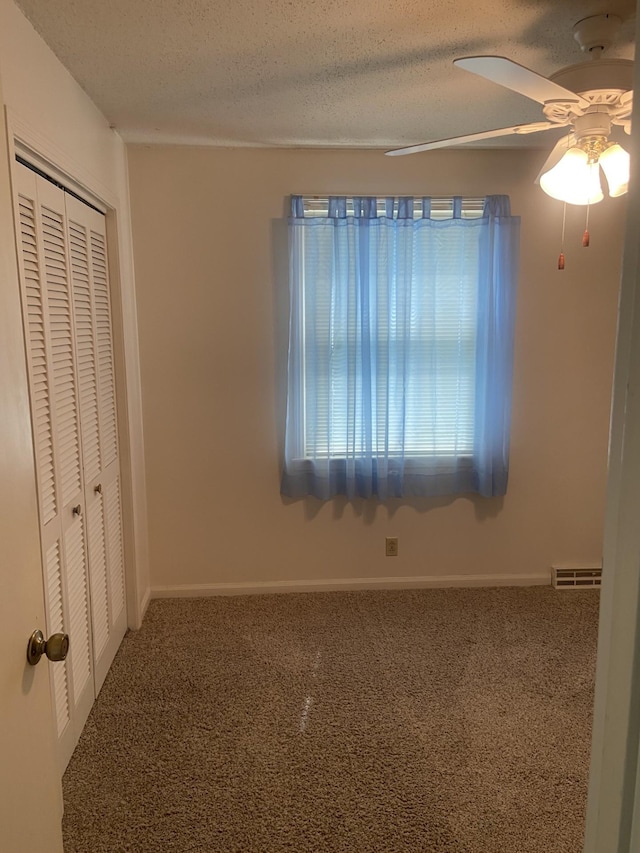 2169 Post Rd, Clarksville, TN 37043 - unfurnished bedroom with a ceiling fan, a textured ceiling, visible vents, a closet, and carpet flooring