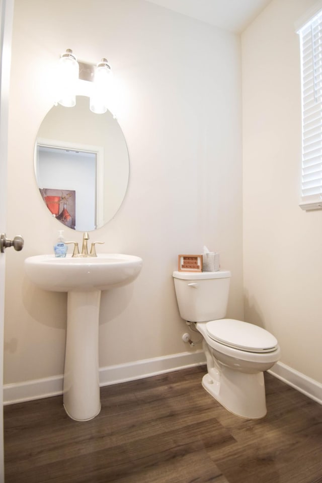bathroom featuring wood finished floors, toilet, and baseboards