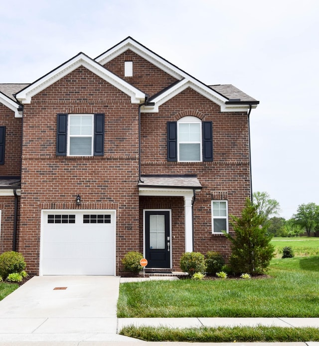 traditional-style house with a garage, brick siding, and concrete driveway