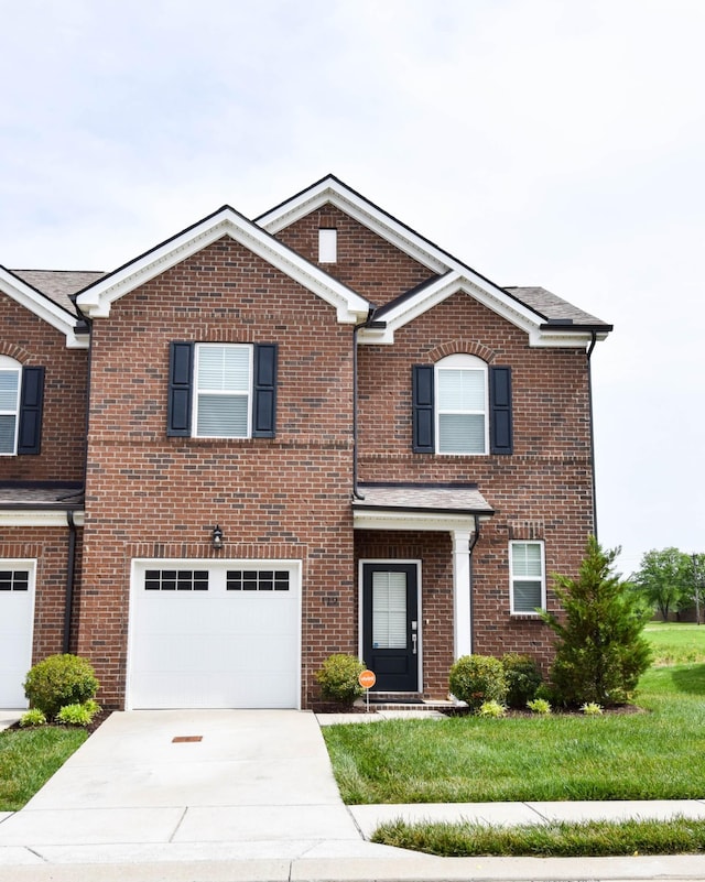 view of front of house with driveway, brick siding, and a garage