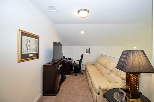 office area with lofted ceiling, baseboards, visible vents, and light colored carpet
