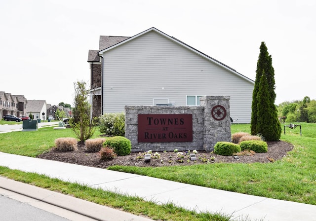 community / neighborhood sign with a lawn