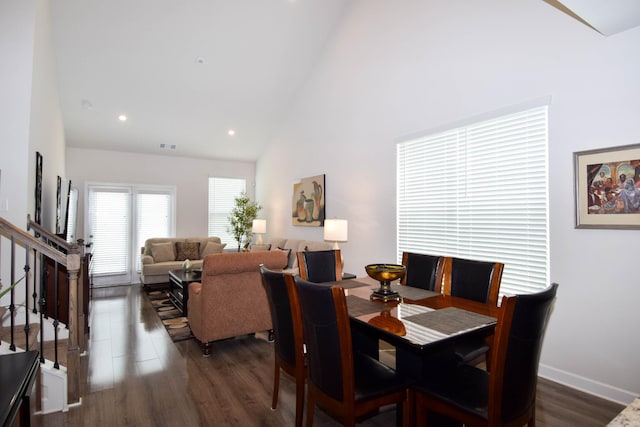 dining space featuring dark wood-type flooring, baseboards, high vaulted ceiling, and recessed lighting