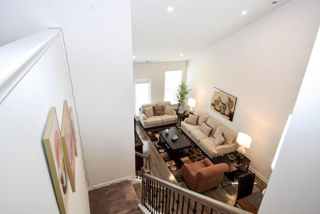 stairs with baseboards, carpet floors, and recessed lighting