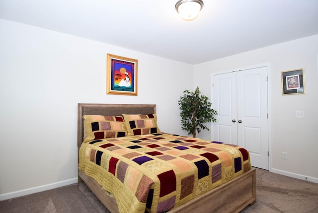 bedroom featuring a closet, carpet flooring, and baseboards