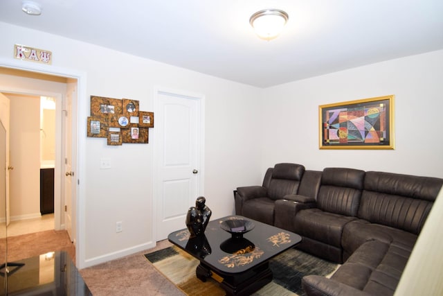 carpeted living room with baseboards