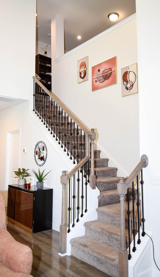 stairway with wood finished floors and baseboards