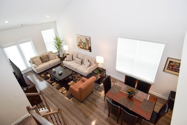 living room with baseboards, wood finished floors, visible vents, and recessed lighting