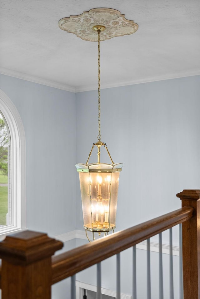 details with ornamental molding and an inviting chandelier