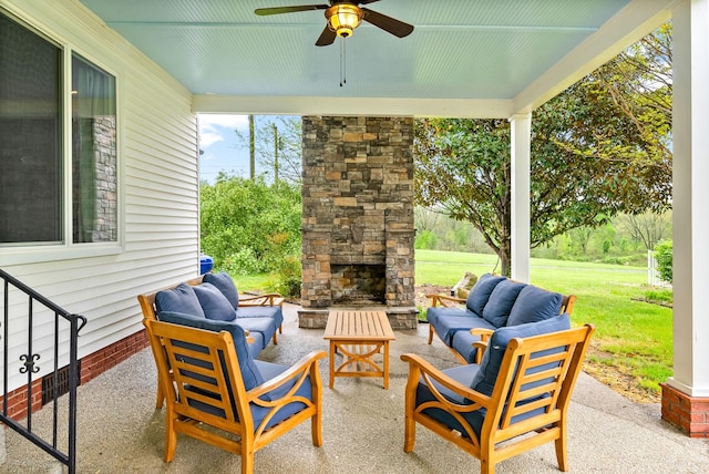 view of patio / terrace featuring an outdoor living space with a fireplace and a ceiling fan