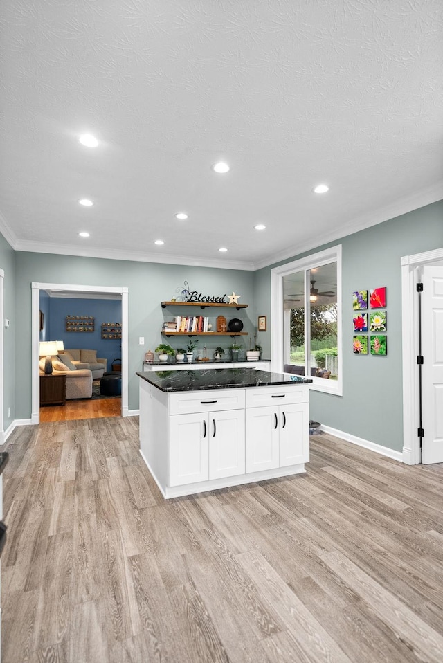 kitchen featuring crown molding, open shelves, light wood-style floors, baseboards, and white cabinetry