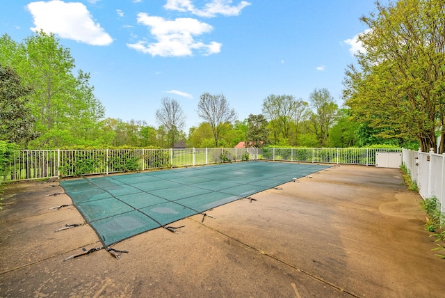 view of swimming pool featuring fence, a patio, and a fenced in pool