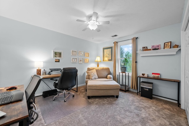 carpeted office featuring visible vents, baseboards, and ceiling fan