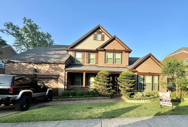 416 Mackenzie Way, Franklin, TN 37064 - craftsman-style home with a front lawn, brick siding, a garage, a porch, and driveway