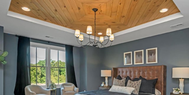 bedroom with visible vents, a chandelier, a tray ceiling, and wooden ceiling