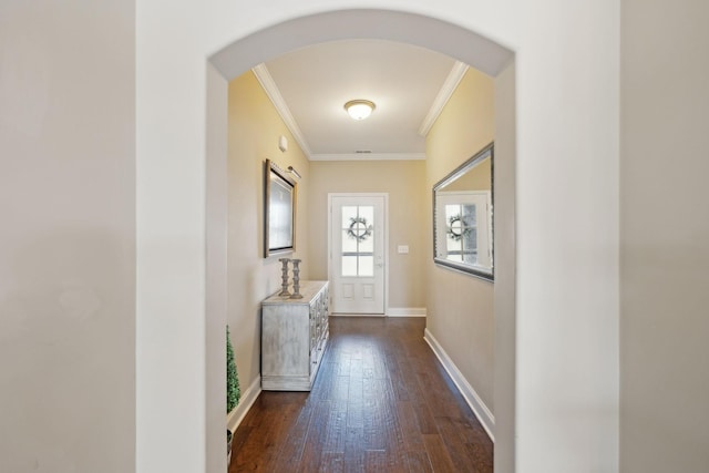 doorway with baseboards, arched walkways, dark wood-type flooring, and ornamental molding