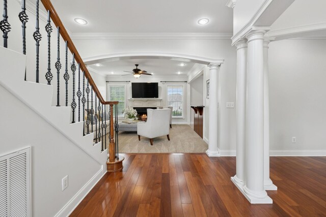 132 Thornwood Pl, Hendersonville, TN 37075 - foyer with a ceiling fan, a lit fireplace, dark wood-type flooring, visible vents, and decorative columns