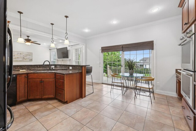 132 Thornwood Pl, Hendersonville, TN 37075 - kitchen with a sink, baseboards, freestanding refrigerator, pendant lighting, and crown molding