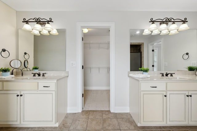 132 Thornwood Pl, Hendersonville, TN 37075 - bathroom featuring a spacious closet, a sink, tile patterned flooring, and two vanities