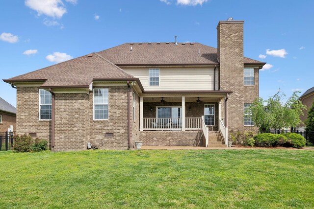 132 Thornwood Pl, Hendersonville, TN 37075 - back of house with fence, a lawn, a chimney, and covered porch