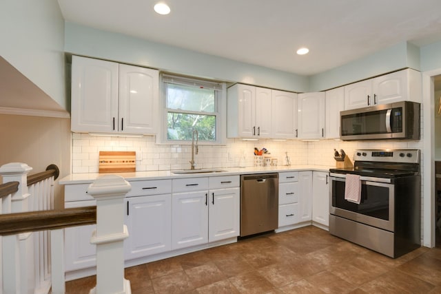 3201 Healy Dr, Nashville, TN 37207 - kitchen featuring white cabinets, appliances with stainless steel finishes, decorative backsplash, and a sink