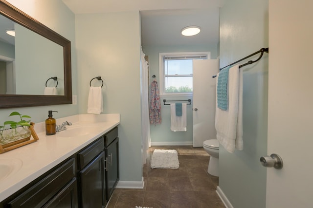 3201 Healy Dr, Nashville, TN 37207 - full bath with a sink, toilet, double vanity, baseboards, and tile patterned flooring
