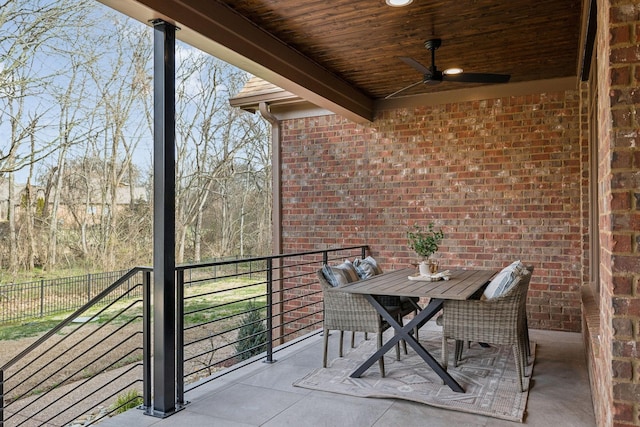 balcony with outdoor dining space and ceiling fan