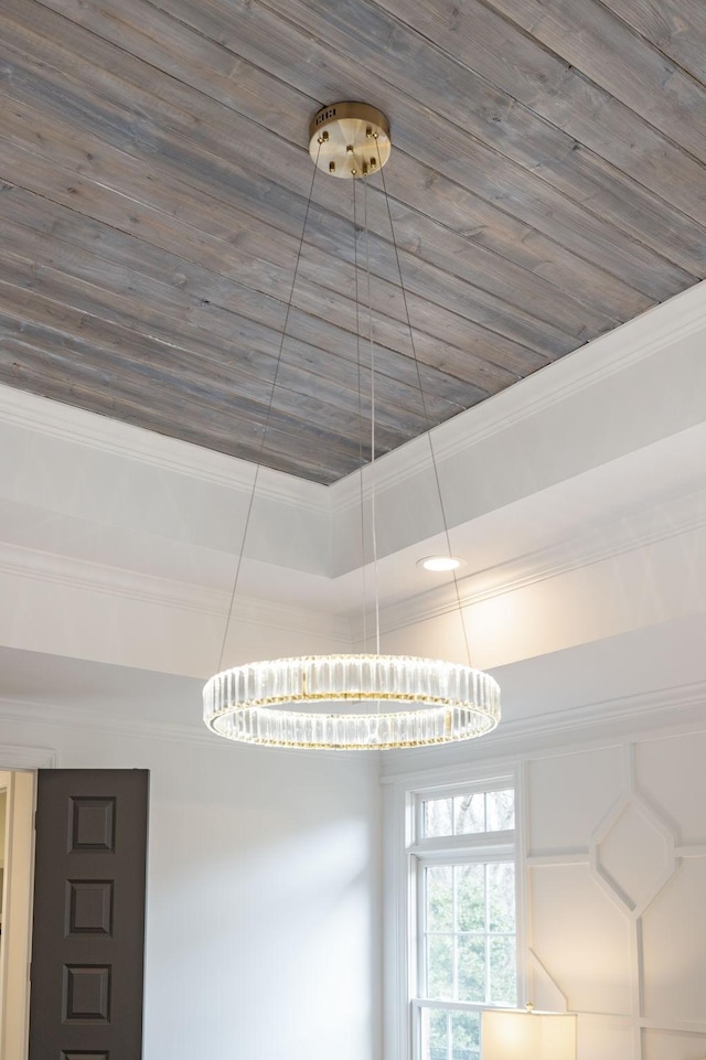 room details featuring a chandelier, crown molding, and wooden ceiling