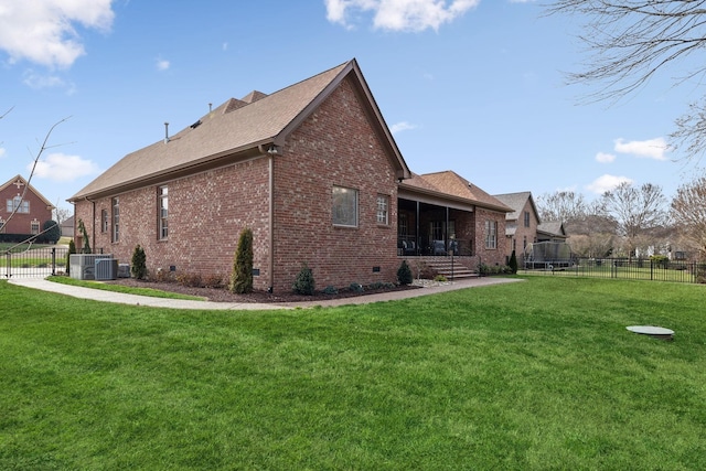 view of side of property with a lawn, brick siding, fence, and cooling unit