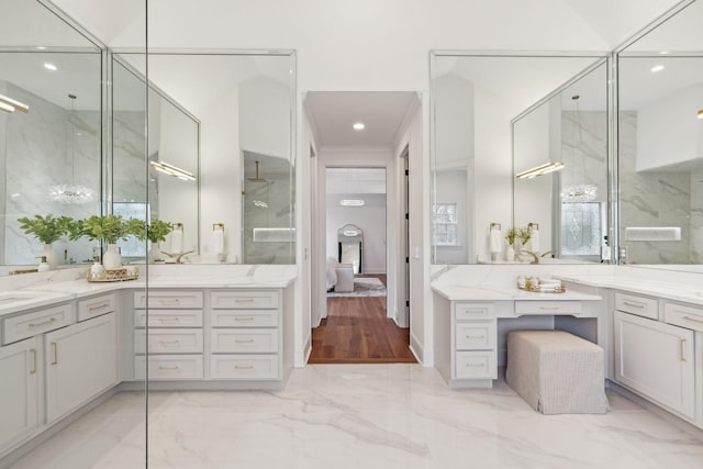 ensuite bathroom featuring vanity, marble finish floor, connected bathroom, and recessed lighting