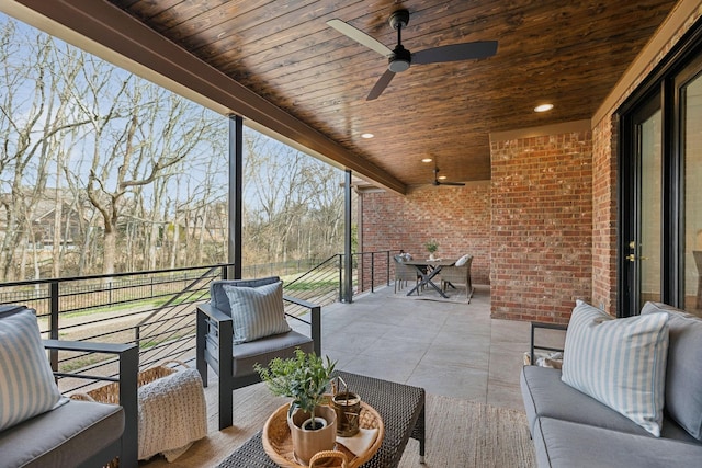 view of patio featuring an outdoor hangout area, outdoor dining space, a balcony, and ceiling fan