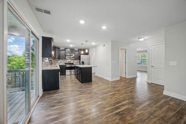 1200 Eagles Bluff Dr, Clarksville, TN 37040 - kitchen featuring stainless steel appliances, a kitchen island, light countertops, dark wood-type flooring, and recessed lighting