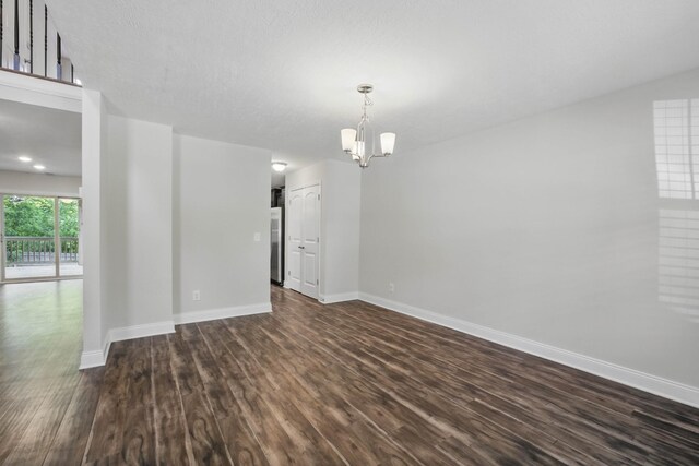 1200 Eagles Bluff Dr, Clarksville, TN 37040 - unfurnished room with dark wood-style floors, baseboards, and a chandelier